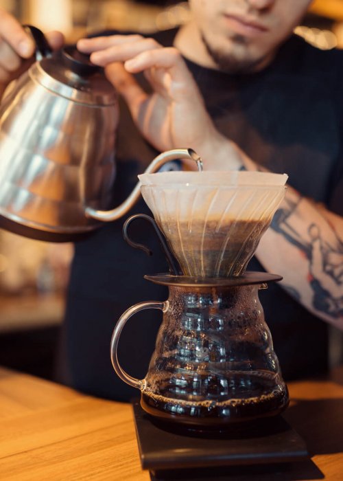 a barista serving Brasilmoka coffee